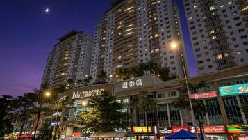 A high-rise building with multiple floors, a prominent 'MAJESTIC' sign, and several ground-level commercial establishments.