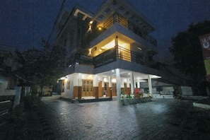 A two-story building with a covered entrance and a balcony on the upper floor. - Namasthe Wellness Hotel (Aluva)