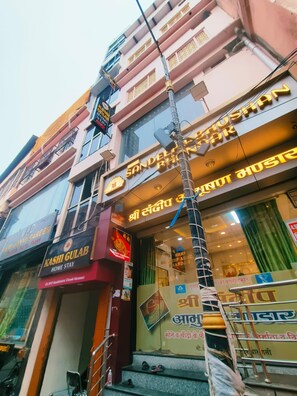 A multi-story building with signage for 'Shri Tandiya Home Stay' and 'Kashi Gulab Home Stay'. - Kashi Gulab Homestay (Varanasi)