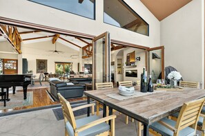 A spacious living area with a dining table, chairs, a piano, and a large mirror reflecting the room. - Private Pool + Hot Tub + Snooker | 42-Acre Vineyard | The Villa at Ambyth Estate (Templeton)