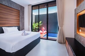 A hotel room with a bed, a TV, a sliding glass door leading to a pool area with a flamingo float. - Cozy 2 BR Nusa Dua Villa with Private Pool (Badung)