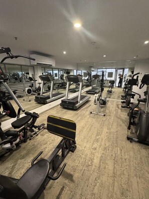 A gym with treadmills, weight machines, and exercise equipment. - The Sand Resort | Coastal Studio with park view (Kingscliff)