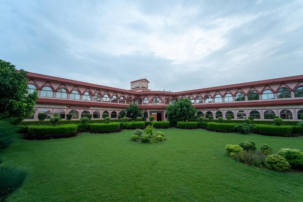 A large building with a central courtyard, multiple arches, and a symmetrical design.