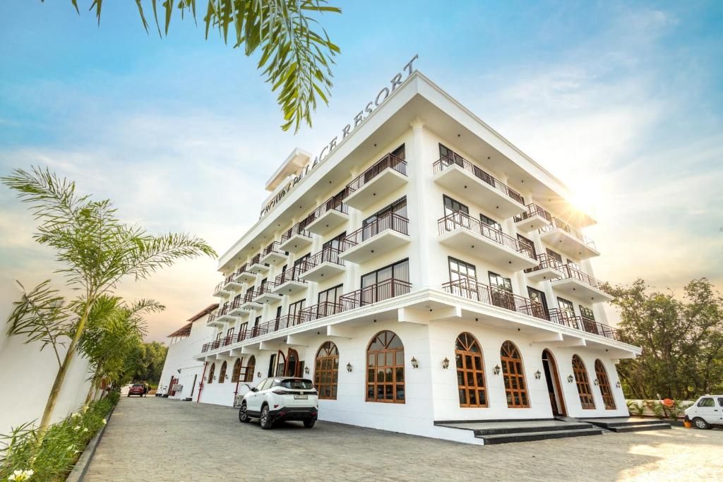 A multi-story hotel with balconies, arched windows, and a clear sky.