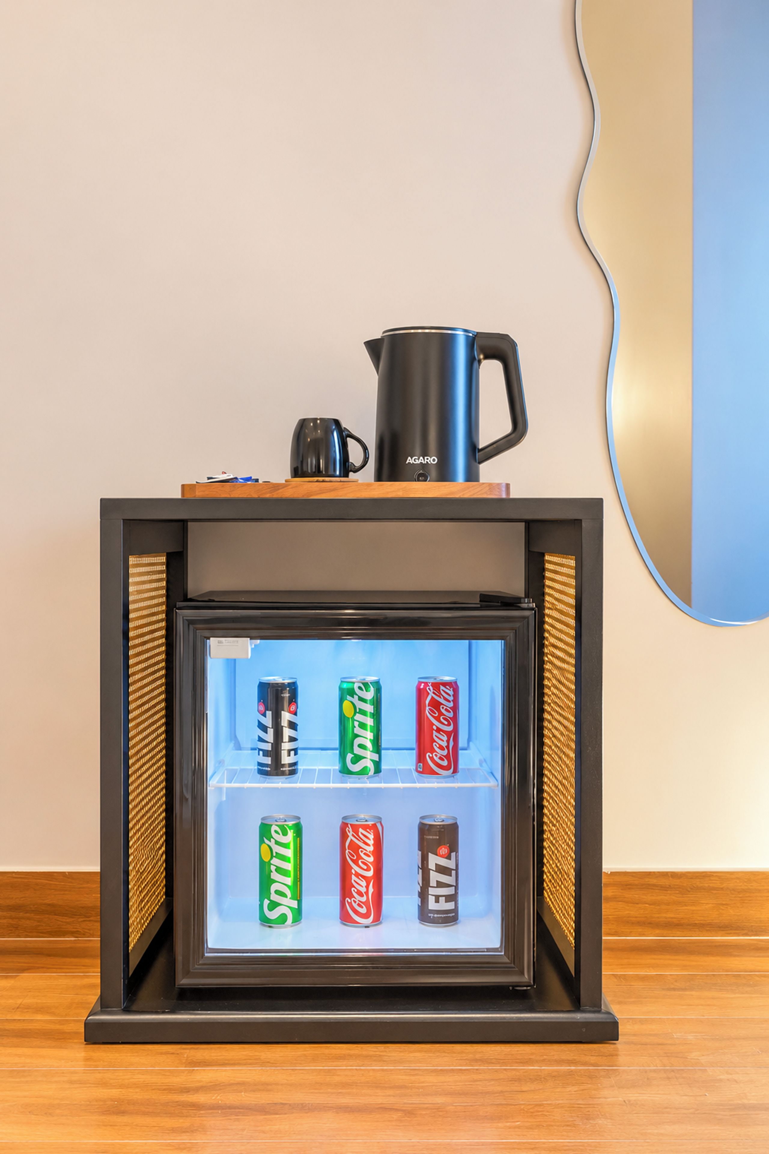 A minibar with a beverage dispenser and a coffee pot.