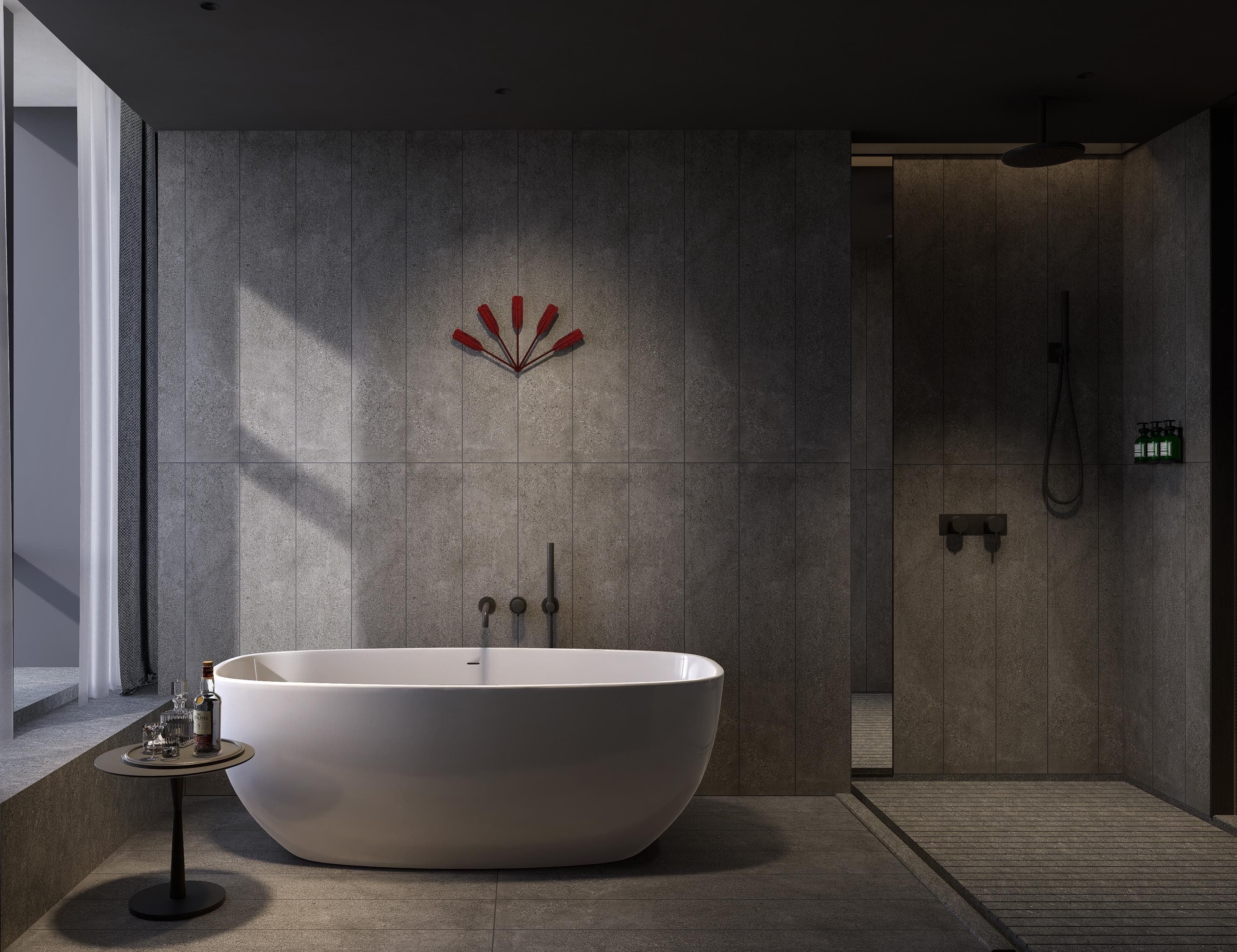 A modern bathroom with a freestanding bathtub, a wall-mounted shower, and a small table with glasses and a bottle.