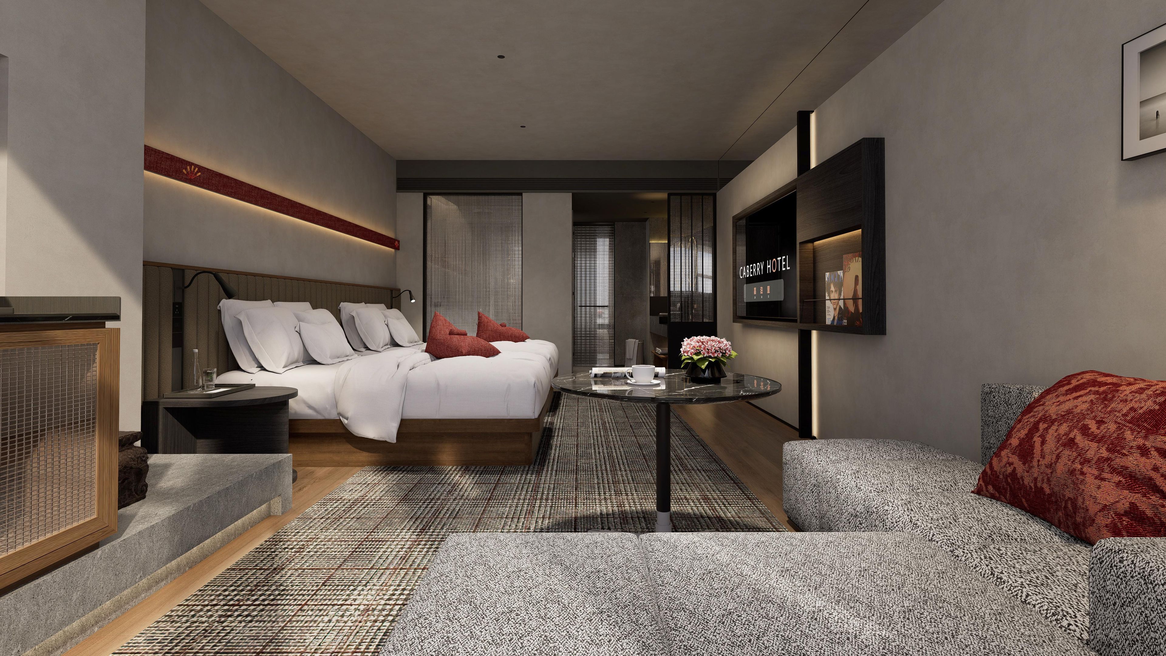 Una habitación de hotel moderna con cama, zona de estar, una mesita y televisor montado en la pared.