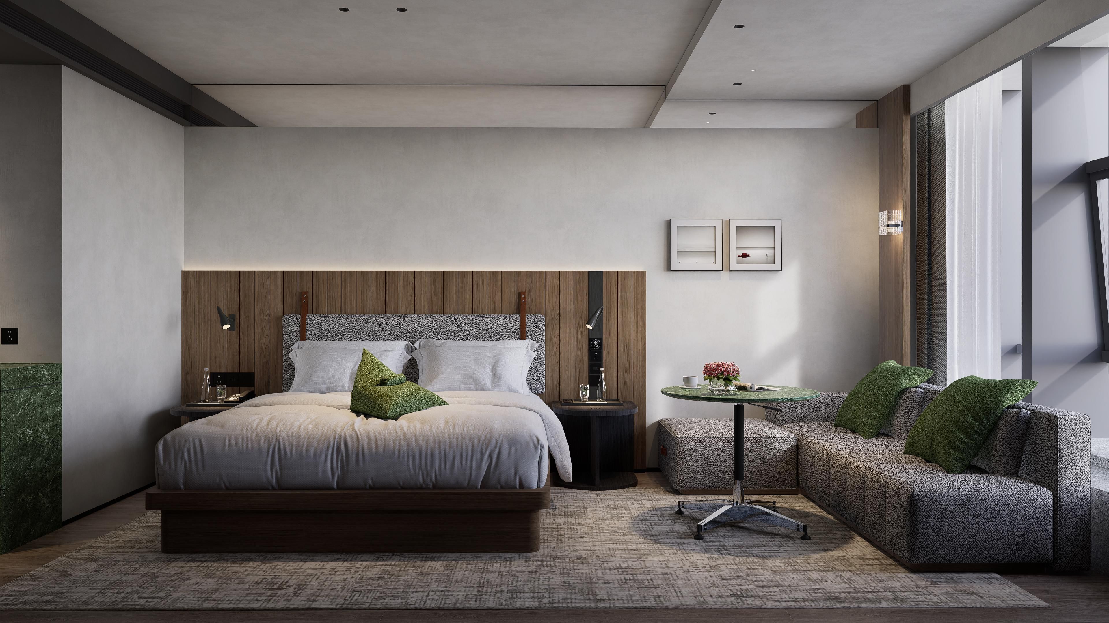Une chambre moderne avec un grand lit, un petit canapé, une table ronde et une vue sur l’extérieur.