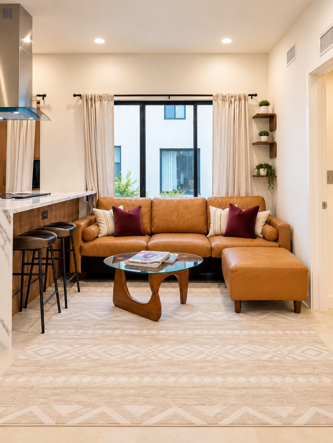 Stylish and inviting living room featuring a gorgeous leather sectional sofa, warm accent pillows and natural light — your perfect place to relax and unwind after a day exploring the best of Miami!