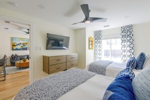 A modern bedroom with a bed, a TV, a wardrobe, and a ceiling fan. - Steps to Blue Mountain Beach! 30A Getaway w/ Deck (Santa Rosa Beach)