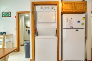 A kitchen with a double-door refrigerator, a built-in oven, and wooden cabinets. - Walk to Swift's Beach! Cozy Home Near Cape Cod (Wareham)