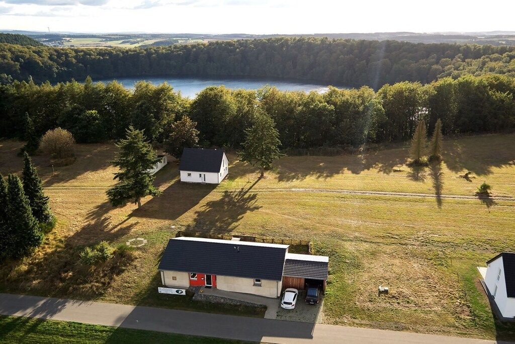 A rural property with a house, a garage, and a driveway.