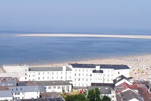 A coastal hotel with a beach view, multiple floors, and a flat roof. - Wille in the beach villa Möwennest (Borkum)