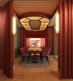 A dining area with a round table, chairs, and a patterned floor rug. - Hotel Fenix Sevilla by Vibra - New Opening 2027 (Seville)