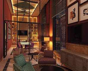 A modern interior with a seating area, bookshelves, and a television. - Hotel Fenix Sevilla by Vibra - New Opening 2027 (Seville)