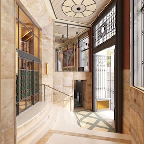 A modern interior with a marble staircase, a decorative ceiling, and a view through a glass door. - Hotel Fenix Sevilla by Vibra - New Opening 2027 (Seville)