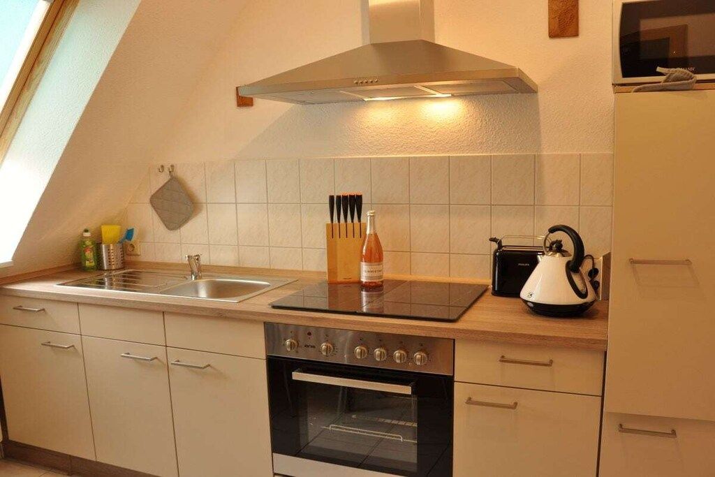A kitchen with a stove, oven, and a microwave.