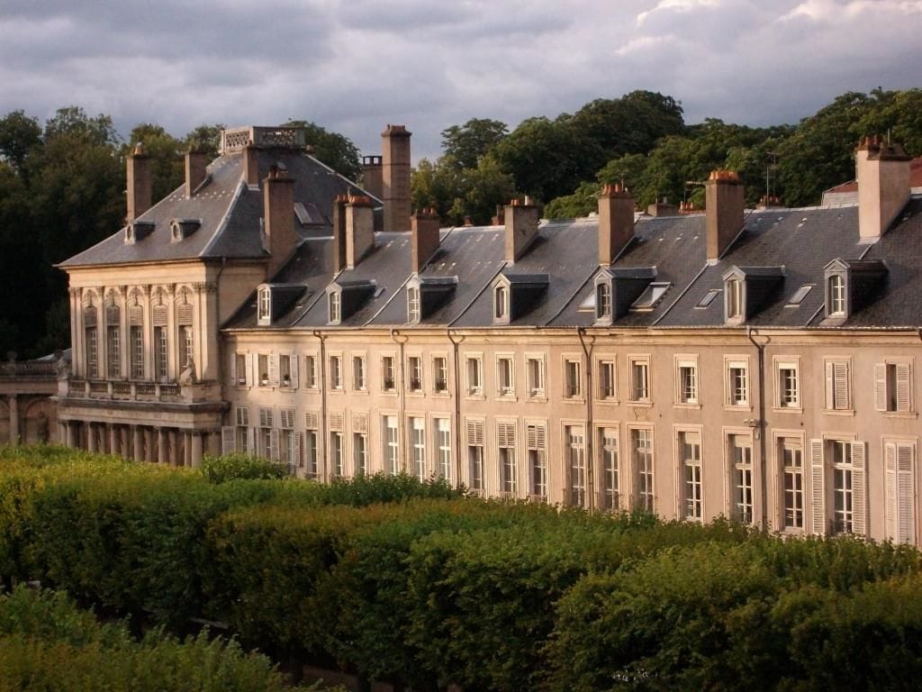 A large, historic building with multiple levels and a symmetrical facade.