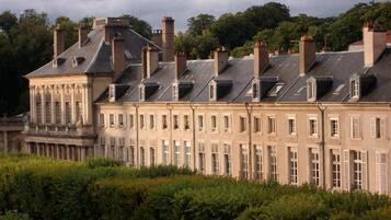 A large, historic building with multiple levels and a symmetrical facade.