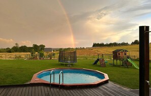 A backyard with a hot tub, a trampoline, and a playground. - Nice home in Rusinowo with outdoor swimming pool (Rusinowo)