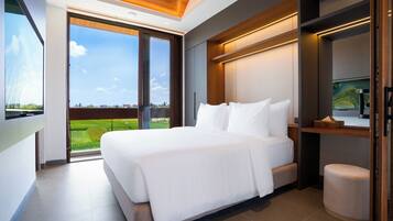 A modern bedroom with a large bed, a view of the outdoors, and a built-in TV.