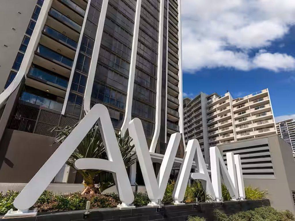 A modern building with large white letters spelling 'AVAI' on the ground.