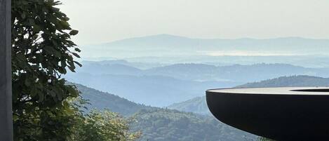 Vista de un paisaje montañoso con una gran estructura negra al primer plano.