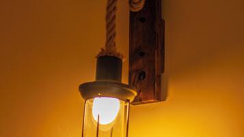 A wall-mounted light fixture with a rope decoration.