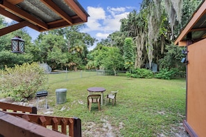 Unclassified image, 2 of 44, button - Escape to a quiet wooded retreat in New Smyrna Beach. This charming 2BR/1BA home features two queen bedrooms, an open kitchen and living area, dining for six, a screened front porch and covered back porch for relaxing and enjoying nature. (New Smyrna Beach)