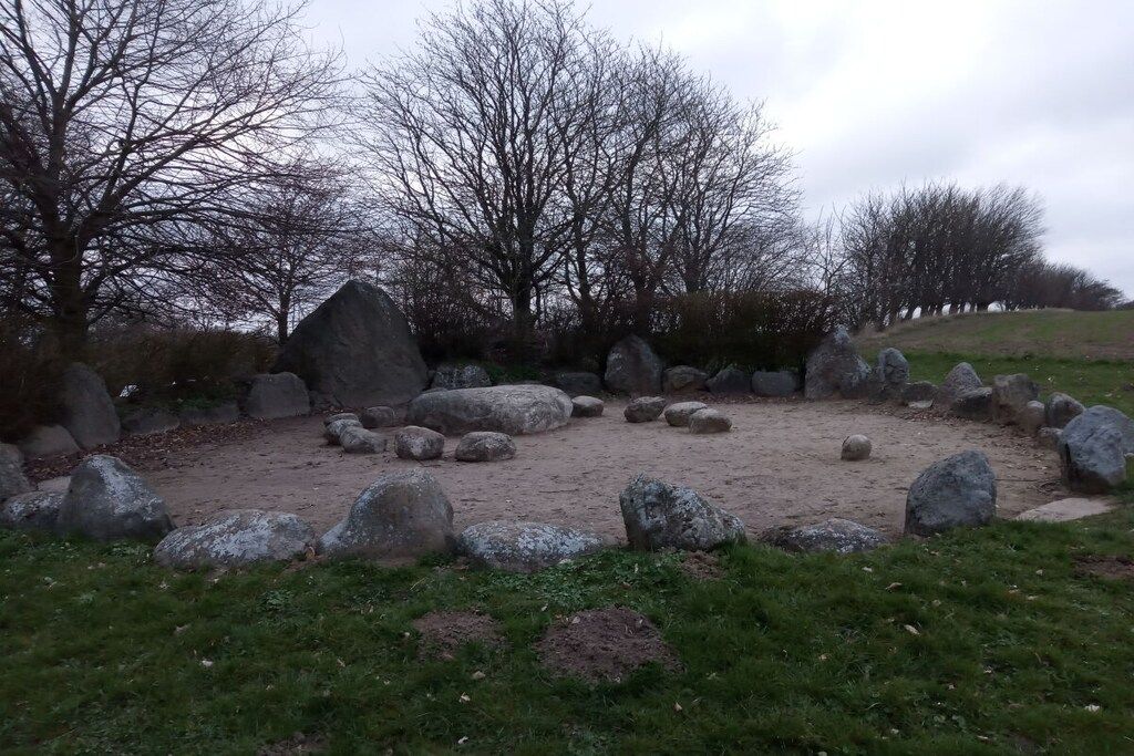 A natural outdoor area with large rocks and leafless trees.