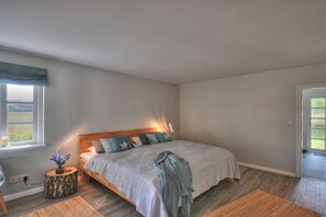 A bedroom with a bed, bedside table, and a window. - Holiday home in Sörup with swimming pool (Sörup)