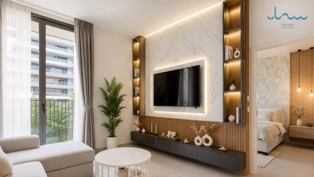 Uma sala de estar moderna com uma televisão de tela plana grande fixada na parede, um sofá, uma mesa de centro e um vaso com planta.