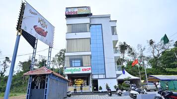 A multi-story building with a prominent sign for a family restaurant and private lounge.