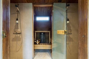 A traditional Japanese-style room with a wooden interior, a built-in fireplace, and a small shelf with a pot and a ladle. - Stay North - Apple House (Kangasala)