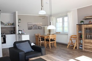 A compact living space with a dining area, kitchenette, and a seating area with a sofa and table. - Open the door and off we go Barendorf (Barendorf)