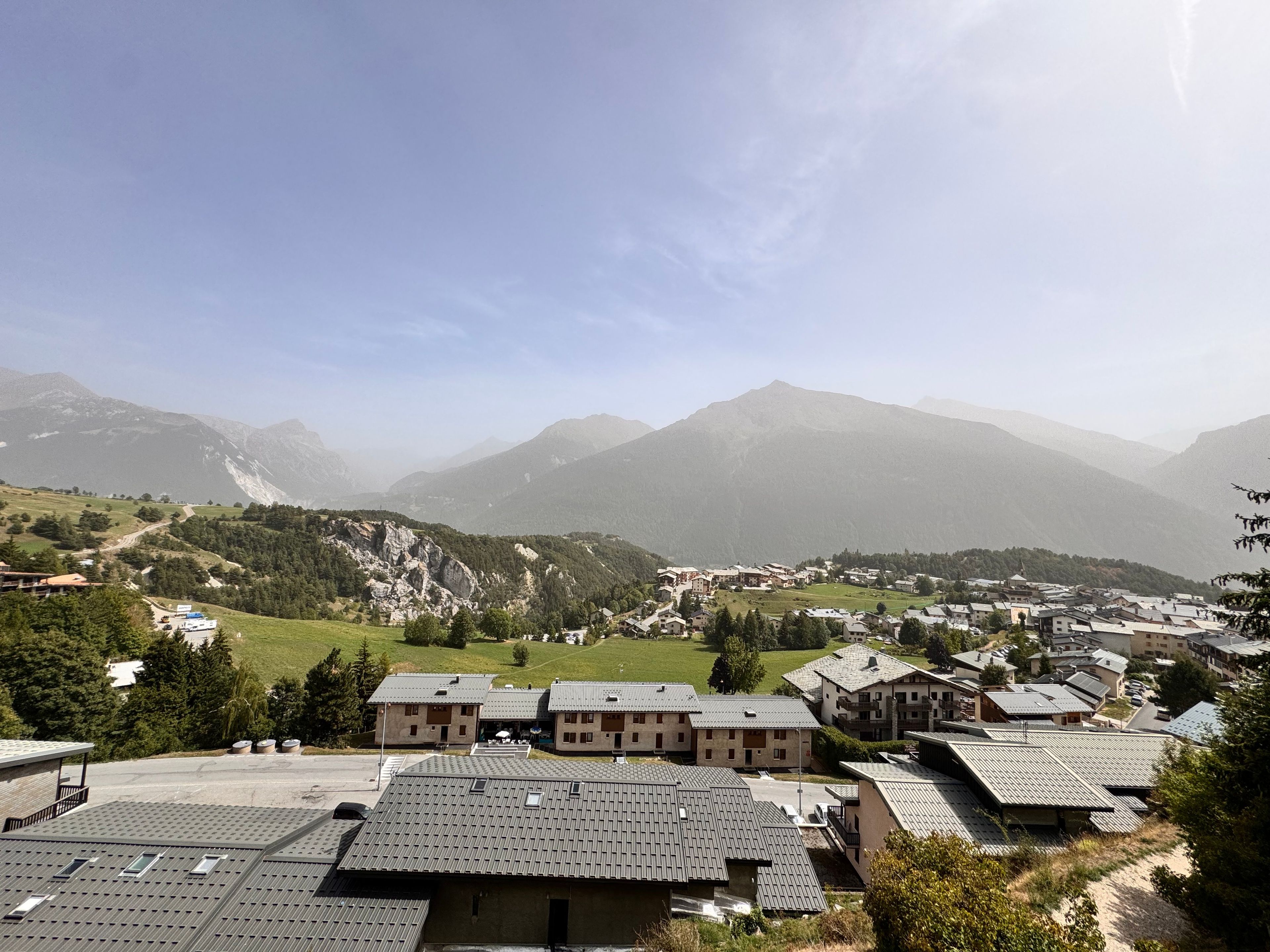 A mountainous village with traditional buildings and a clear sky.