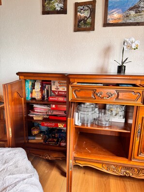 A wooden cabinet with shelves, a small plant, and a framed picture on the wall. - Le Bouquetin en Redingote Chalet: Mountain View, Wi-Fi, Air Conditioning (Aussois)