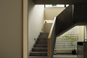 A staircase with a modern design, leading to a second floor.
