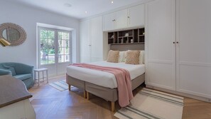 A bedroom with a bed, a sofa, a desk, and a window. - Portuguese mansion close to marina, golf and beach (Quarteira)