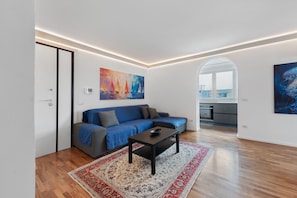 A modern living room with a sofa, coffee table, and artwork on the walls. - Apartment 'Casa della Luna' (Lecce)