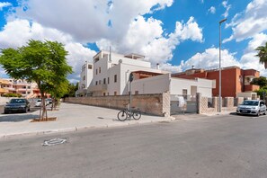A modern building with a flat roof, a bicycle parked in front, and a clear sky. - Apartment 'Casa della Luna' (Lecce)