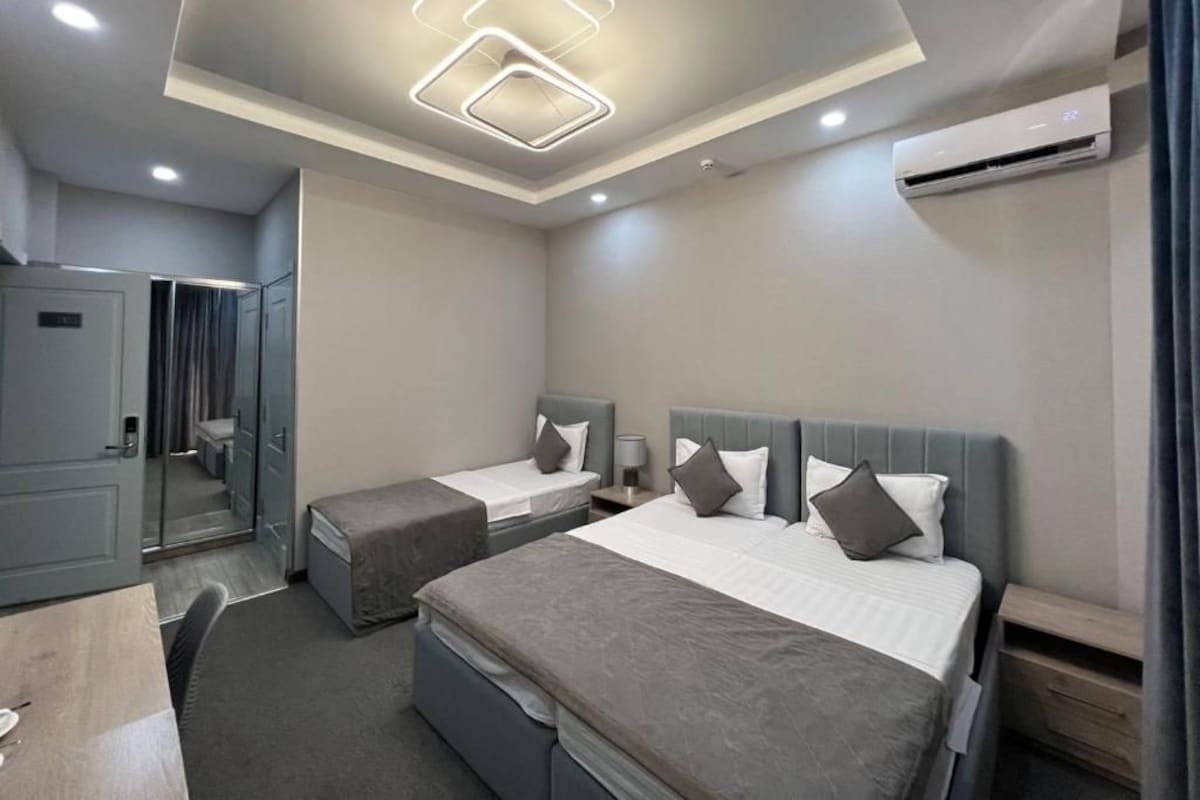 Family Triple Room, Balcony, City View | Desk, laptop workspace, soundproofing, iron/ironing board (on request)