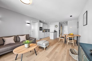 A modern apartment with a living room, kitchenette, dining area, and a small kitchen. - Haus Elisabeth, Apartment 6, on the beach, with an underground parking space, Wi-Fi, and a balcony (Sylt)