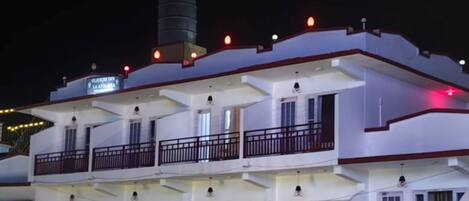 Un edificio de varios pisos con balcones y un cartel que indica que es un hotel.