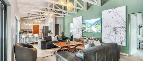 A modern interior with a living area featuring a sofa, coffee table, and pendant lighting.