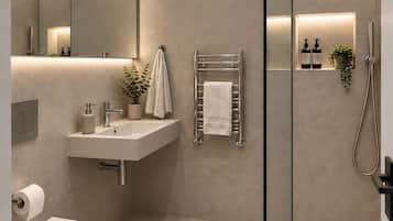 A modern bathroom with a toilet, sink, and shower.