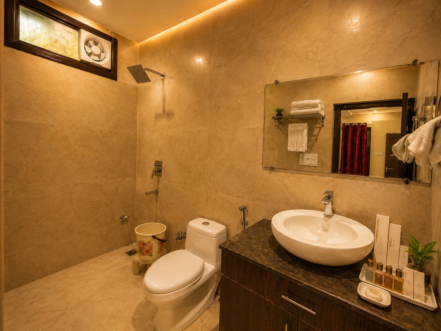A modern bathroom with a toilet, sink, and shower.