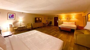 A hotel room with two beds, a desk, a chair, a television, and a door. - Spacious 35 Standard Double Rooms hotel in Presque Isle.Me with fitness room. (Presque Isle)