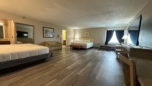 A hotel room with a large bed, a smaller bed, a desk, a chair, and a television. - Spacious 35 Standard Double Rooms hotel in Presque Isle.Me with fitness room. (Presque Isle)