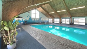 An indoor swimming pool with a tiled floor, wooden ceiling beams, and a mural on the wall. - Spacious 35 Standard Double Rooms hotel in Presque Isle.Me with fitness room. (Presque Isle)